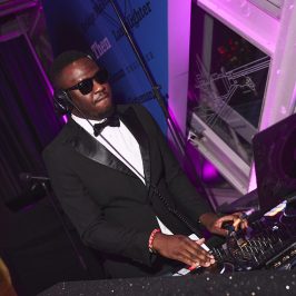 Man in suit and sunglasses dj'ing
